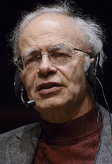 Head shot of Peter Singer speaking to a audience using a microphone